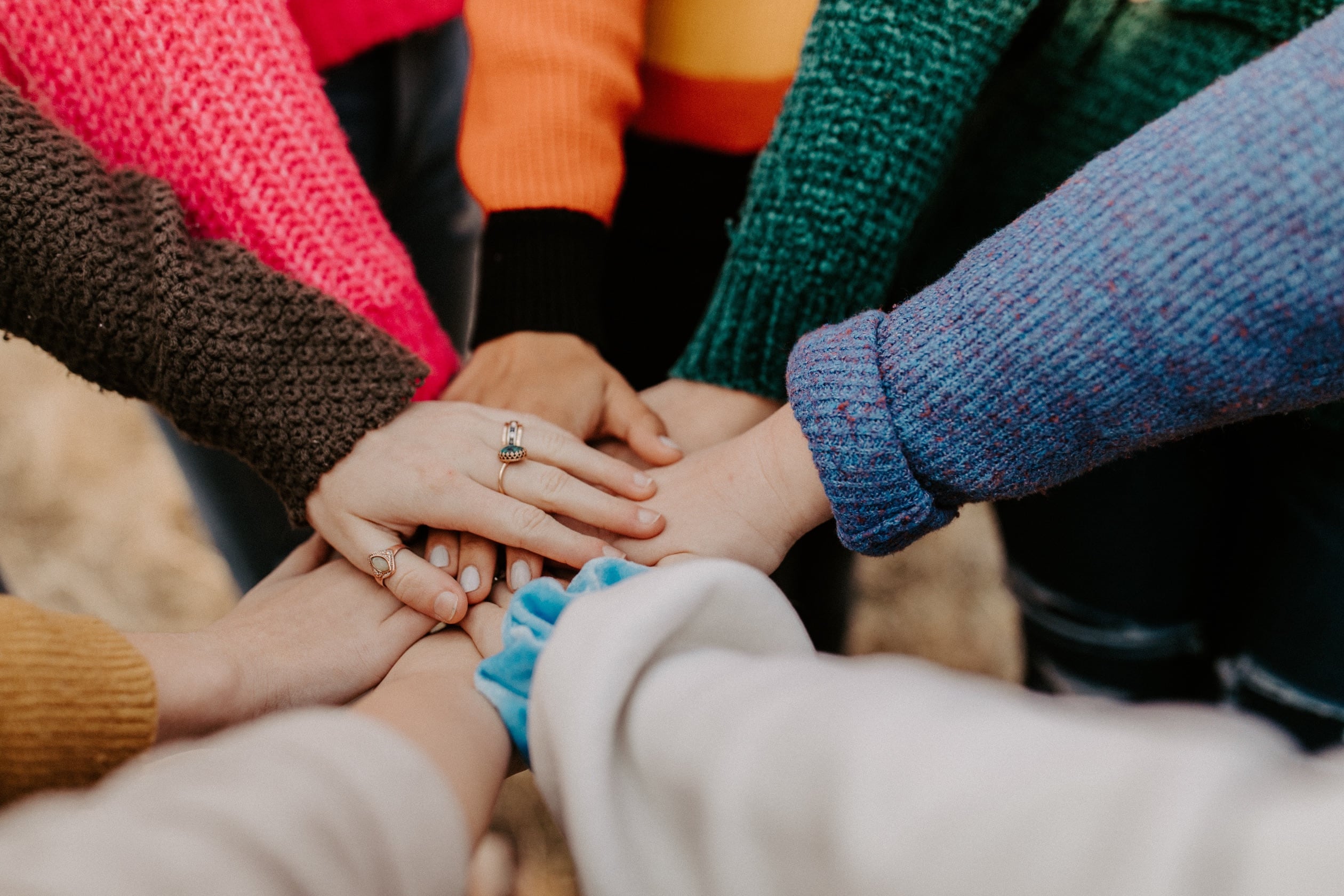 photo of the hands of a group of people coming together